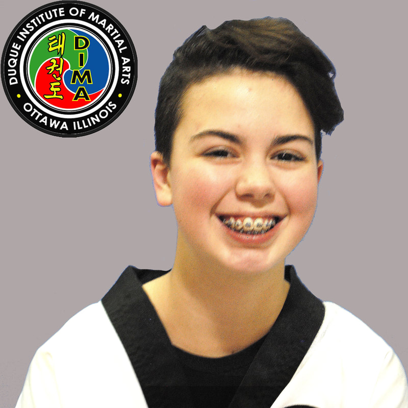 Young girl in taekwondo uniform with short brown hair