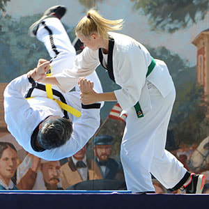 A hapkido green belt throws a hapkido yellow belt