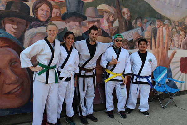 Five hapkido students of very belt levels pose before their demo performance.