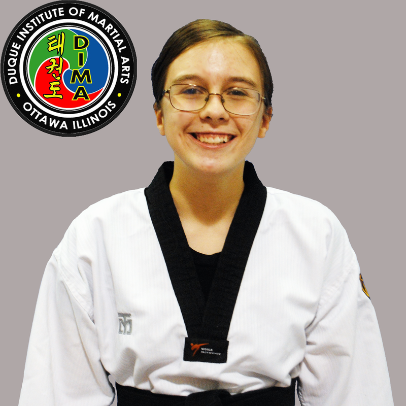 Young girl in taekwondo uniform with dark hair in a ponytail and glasses