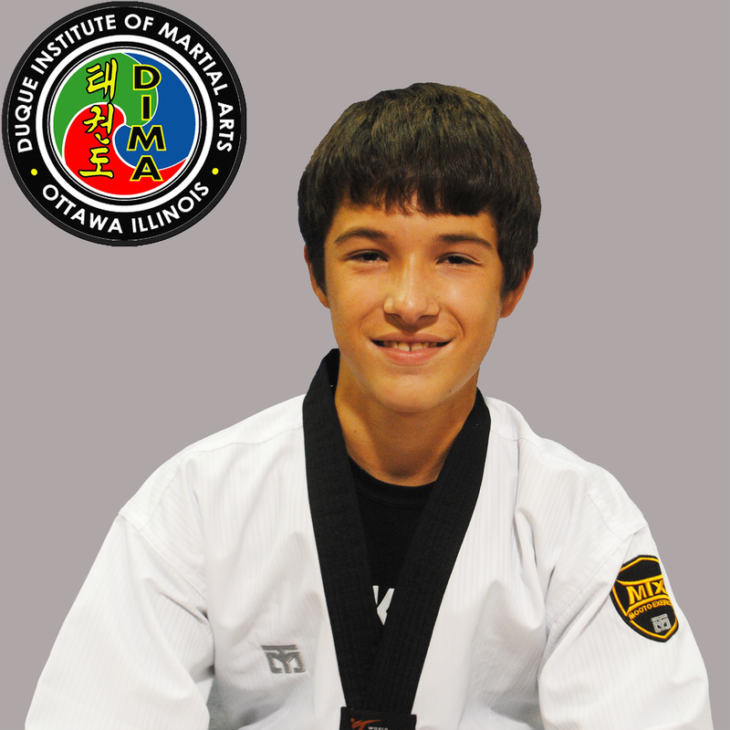 Young boy in taekwondo uniform with short dark hair