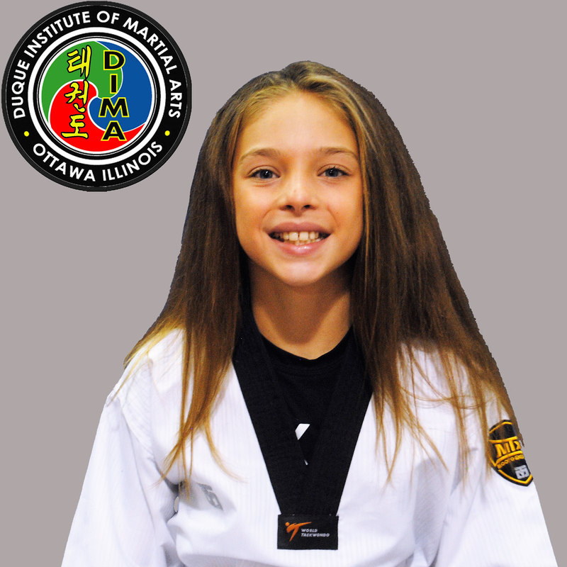 Young girl in taekwondo uniform with long dark hair