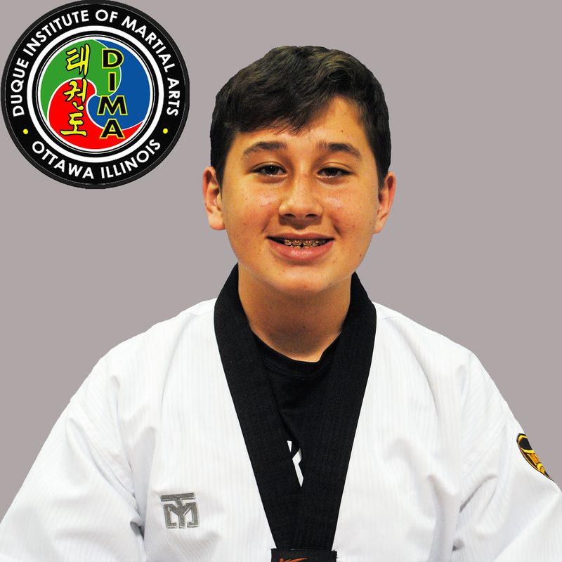Young boy in taekwondo uniform with short dark hair