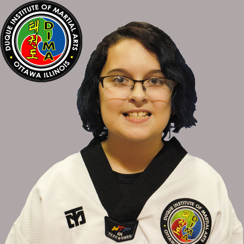 Young girl in taekwondo uniform with medium-length dark hair and glasses